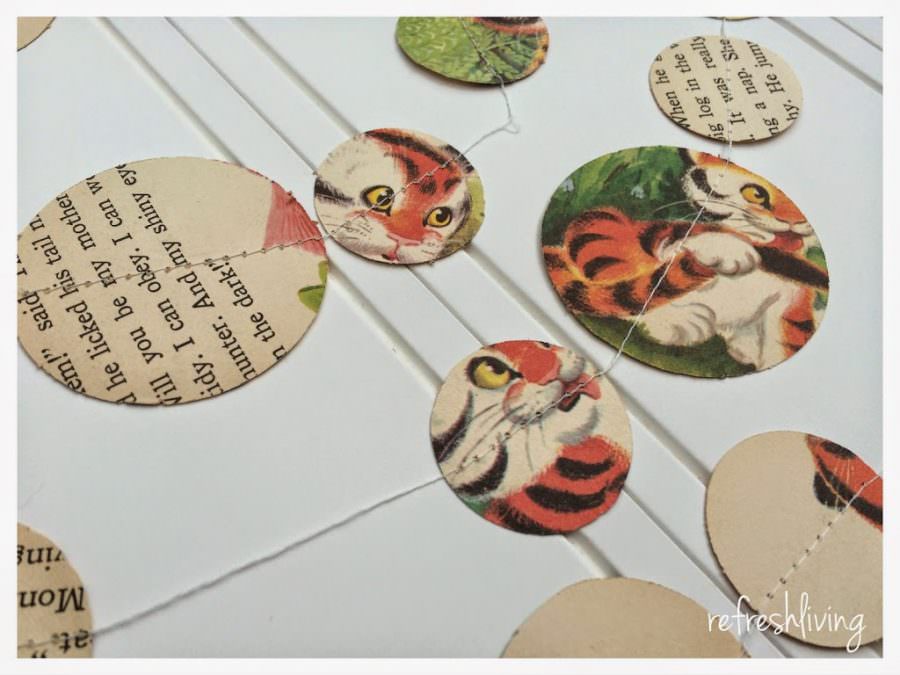 make a DIY garland by sewing together circles cut from paper, childrens books or sheet music