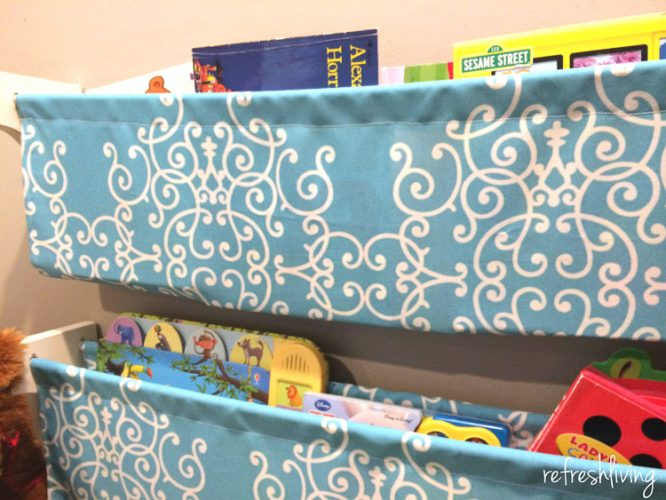 DIY bookshelves using dowel rods and fabric.