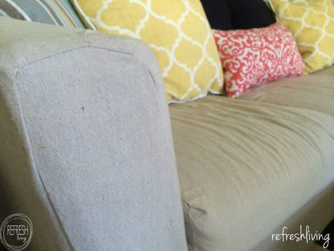 Using a drop cloth to recover a couch or sofa with a slipcover will save you hundreds of dollars! Plus, it's durable enough to hold up to daily use.