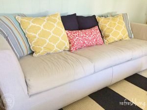 Change the look of your room by making slipcovers for your sofa. Sewing a custom slipcover for your couch is way easier than you might think. Using drop cloth material is a great way to make it a cheap project.