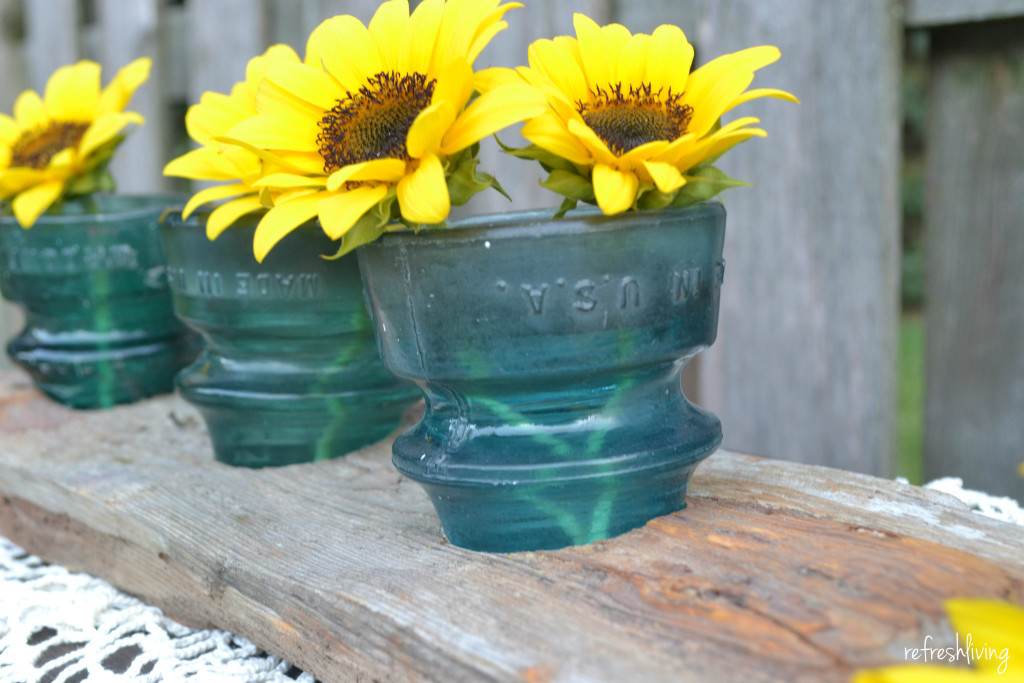 home decor using insulators and dock wood to make small vases or candle holders
