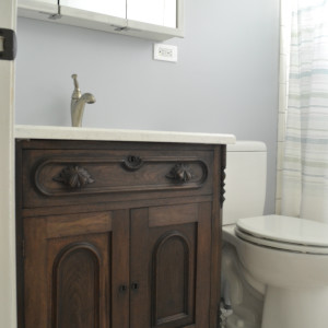 bathroom with antique dresser as vanity