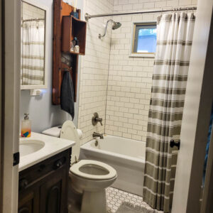 bathroom with subway tile and wood ceiling with painted beadboard