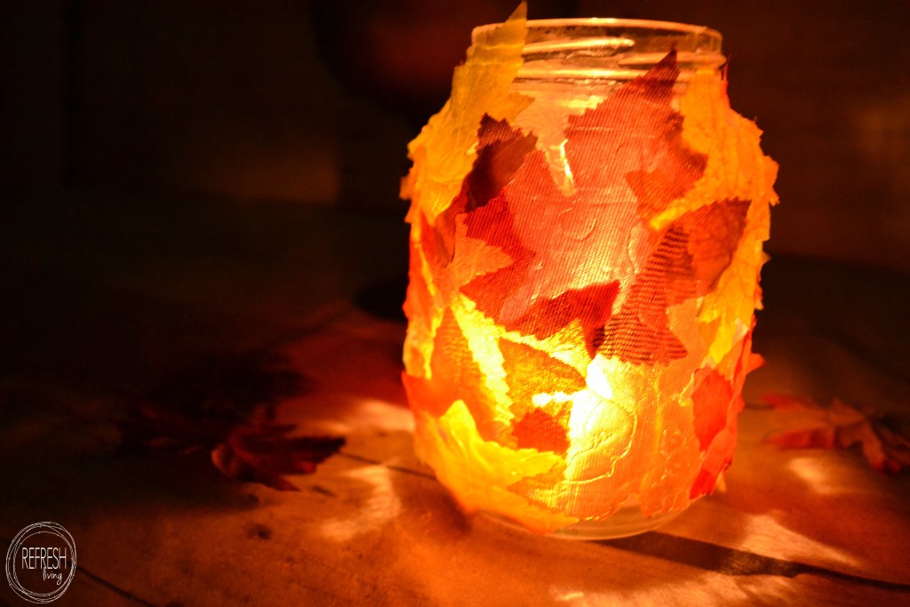 old glass jar with leaves glued on it as fall candleholder DIY