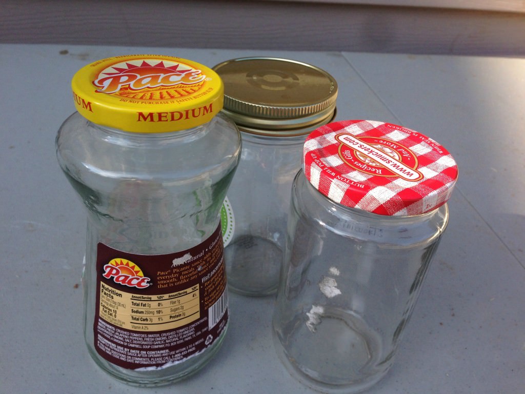 old glass jars reused as bathroom storage 