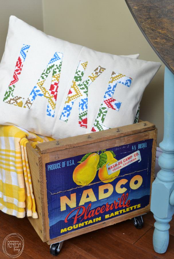 use vintage fabric cut out with cricut to make a lettered pillow cover