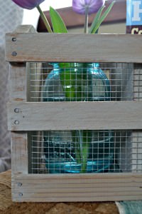 A crate from a thrift store can easily be made into a beautiful farmhouse crate with some chicken wire and a whitewash finish.