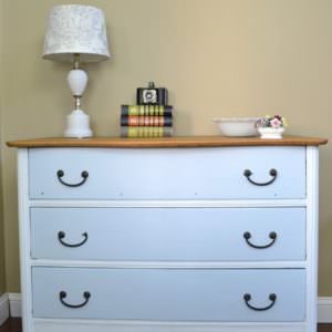 Antique dresser painted with white and turquoise with a natural wood top