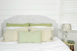 It's easy to make a custom headboard with plywood and a decorative stencil. What a great way to change up bedroom decor without spending a lot of money!