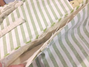 I love how the lining of this pillow cover hides the pillow inside! With this tutorial, it's easy and inexpensive to sew a farmhouse pillow out of a drop cloth.