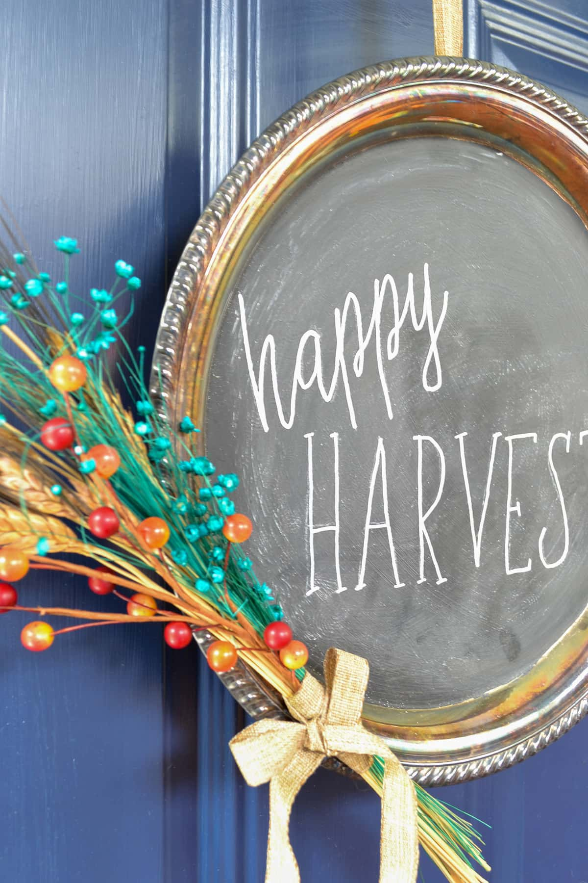 how to make a fall wreath from second hand thrift store finds and chalkboard paint with chalk lettering saying happy harvest