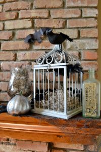 I love this spooky Halloween mantel with vintage thrift store finds and printable images, DIY Halloween decor, and dollar store items. It has an eerie factor without the traditional ghosts and witches.