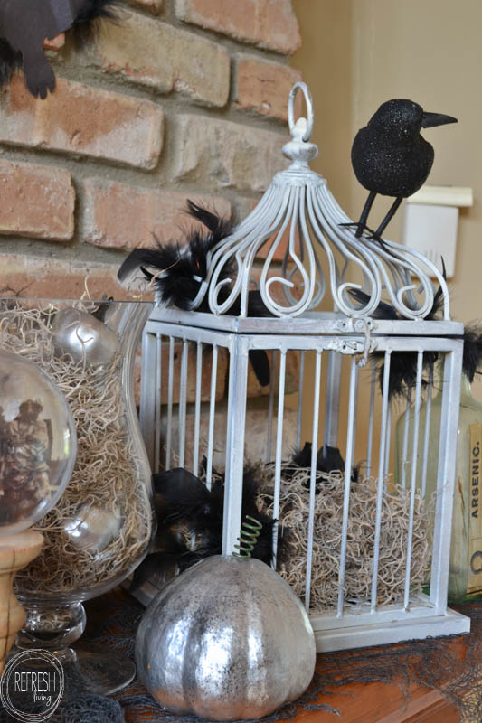 I love this spooky Halloween mantel with vintage thrift store finds and printable images, DIY Halloween decor, and dollar store items. It has an eerie factor without the traditional ghosts and witches.