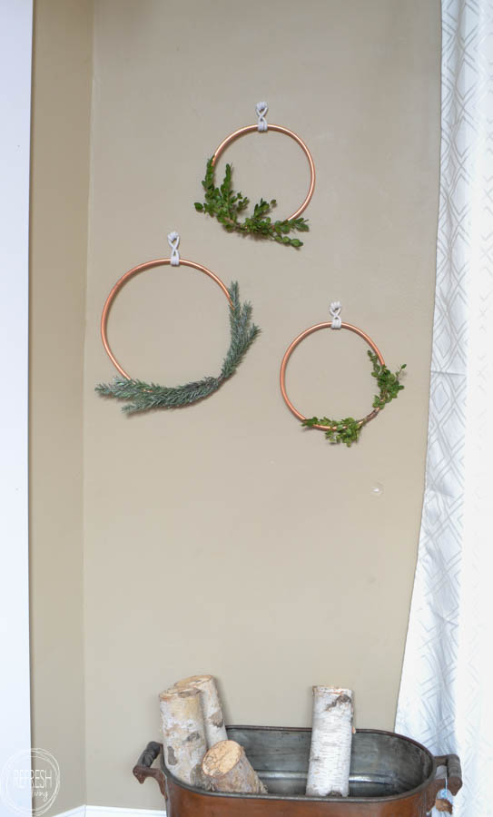 What a great idea to use copper tubing to make a wreath! I love the look of the natural greenery of boxwood and evergreen and the copper..