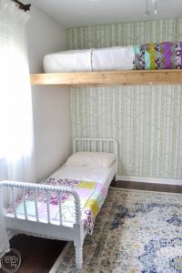 It is possible to create shared kids' bedrooms even in small homes and small rooms! Lofting the bed is such a great way to save space, and it looks amazing too!