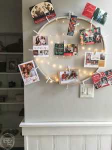 What a smart idea! Use an old embroidery hoop to create a DIY Christmas card holder, complete with copper wire LED lights.