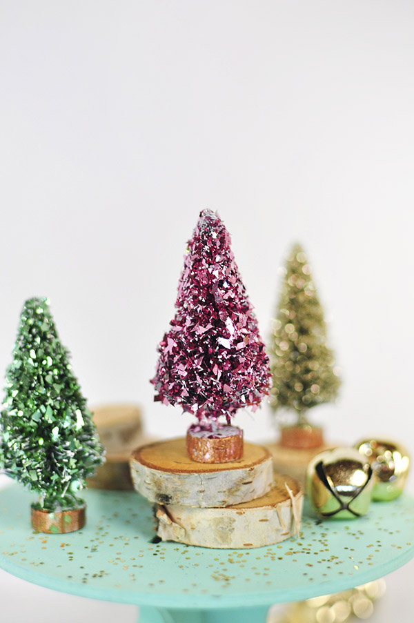 pink bottle brush tree with glitter with 12 other ideas for decorating with bottle brush trees this Christmas