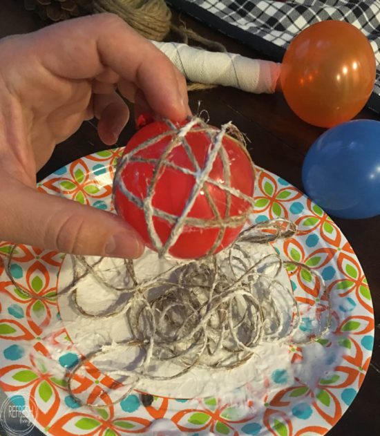 Wrapping twine around water balloons create the perfect shaped rustic twine or string balls to use an fillers for centerpieces or holiday decor.