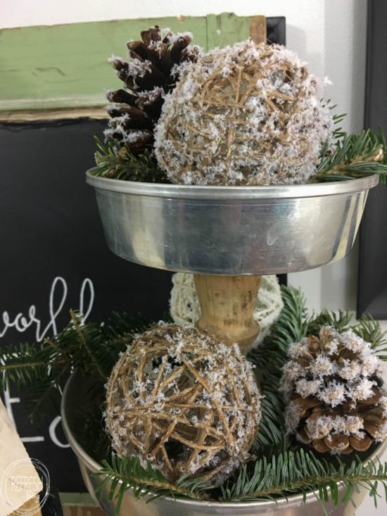 This is my kind of holiday decoration - inexpensive and easy to make! By adding fake snow to pine cones, it's easy to create natural and rustic Christmas decorations.