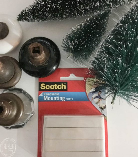 What a great way to display bottle brush trees! Instead of those ugly plastic bases, sit them in vintage door knobs or fun drawers pulls or knobs.