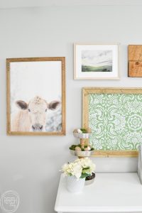 This farmhouse gallery wall has the perfect mix of neutral with a little bit of color. Since I can't have a cow of my own, I'm going to hang one on my wall!
