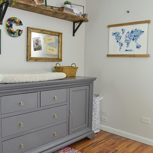 This nursery dresser was updated with a coat of gray paint and new brass pulls.