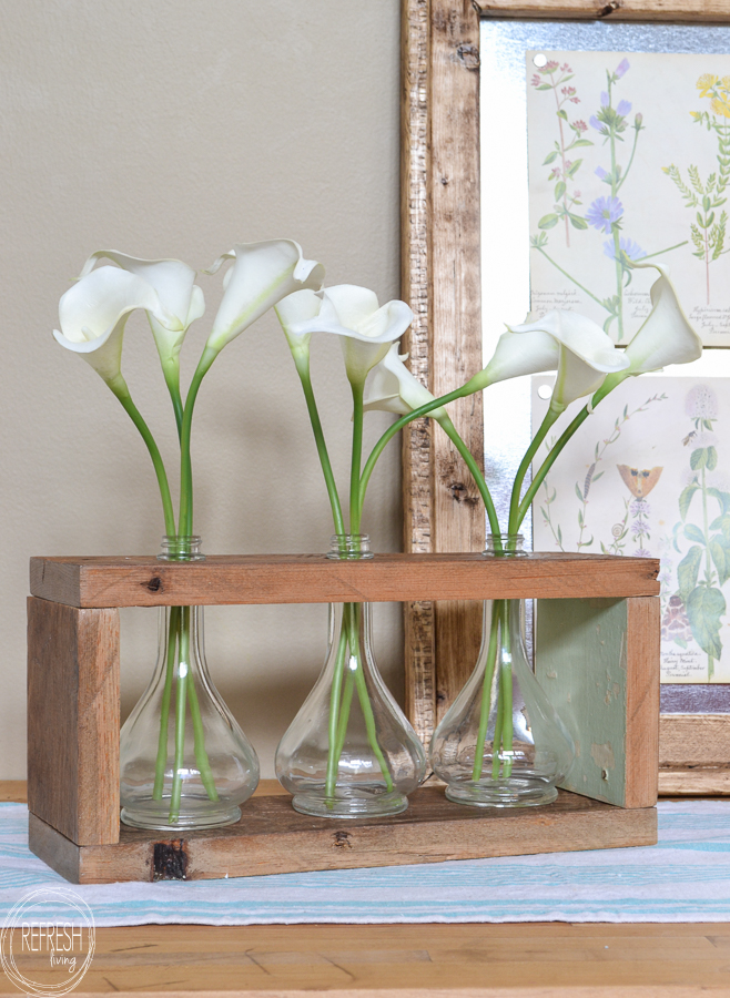 What an easy farmhouse DIY project using old glass jars and reclaimed wood. I love the combination of the barn wood with the glass! Includes a full tutorial.