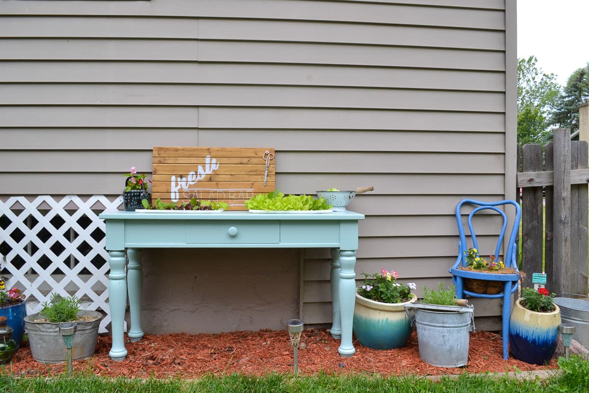 An old sofa table can be reused as a DIY raised garden bed! This is such an easy outdoor project!