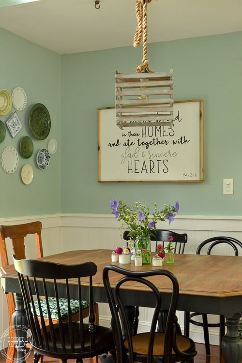 Room makeover completed for under $100 - including a new table and chairs! Vintage modern farmhouse dining room with plate gallery wall and DIY wood sign with quote.