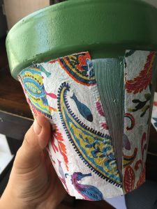 Cheap pots get an update for summer with spray paint and decoupaged napkins.