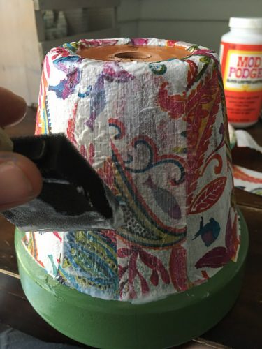 Cheap pots get an update for summer with spray paint and decoupaged napkins.