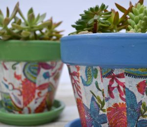 Cheap pots get an update for summer with spray paint and decoupaged napkins.