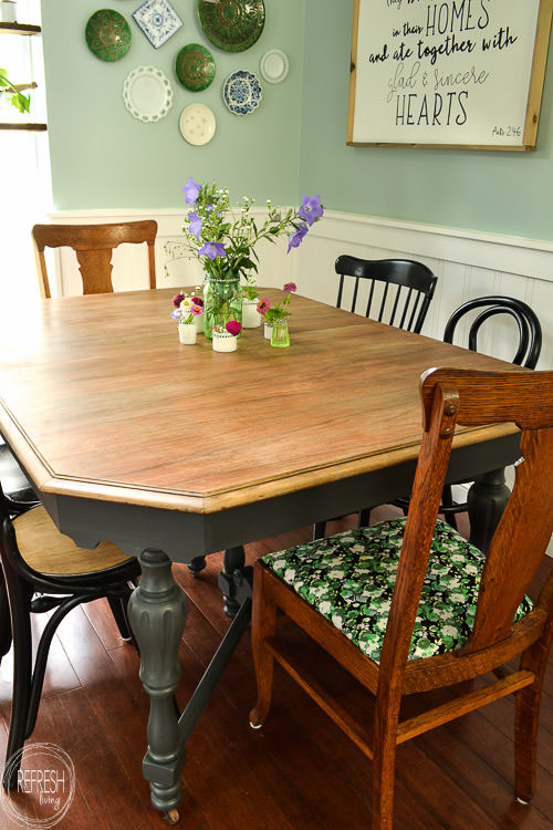 This dining room table only cost $37 at a thrift store! After stripping and bleaching the top and painting the base, it looks like a new piece of furniture! Refinished farmhouse table with natural wood top and painted gray base.