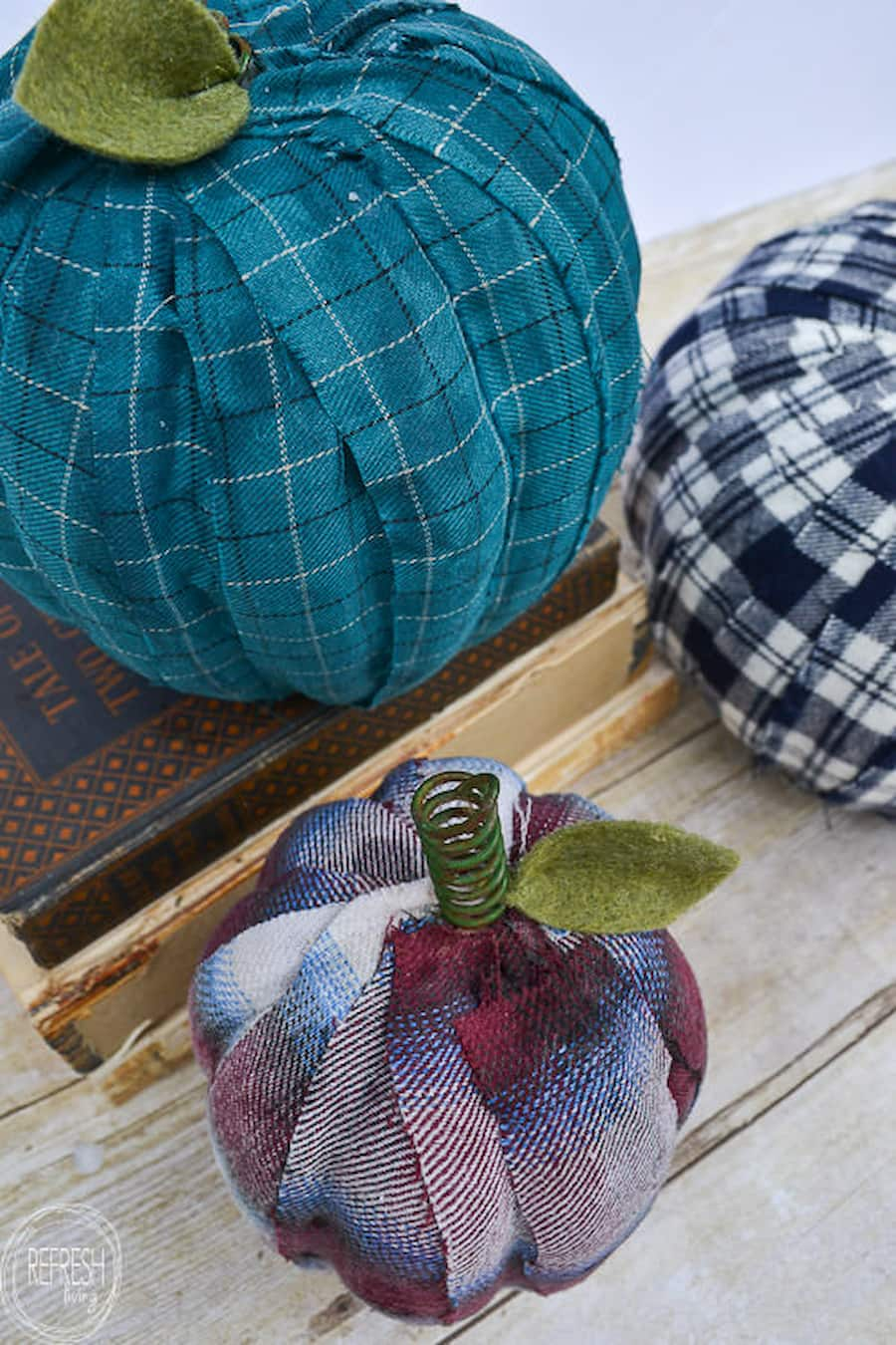 Adding old flannel shirts to pumpkins is a great way to reuse what you already have to create farmhouse decorations for fall.