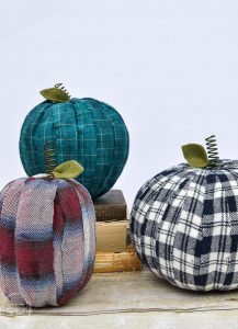 Adding old flannel shirts to pumpkins is a great way to reuse what you already have to create farmhouse decorations for fall.