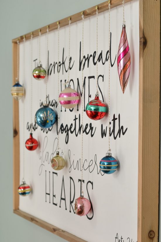 I love the idea to hang ornaments from a sign or piece of art.