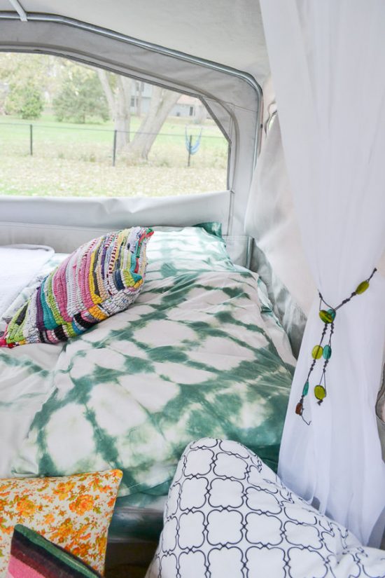 I love the classic look of indigo shibori, but this dark green color is so pretty too. Pop up camper remodel with an eclectic vintage boho feel via Refresh Living.