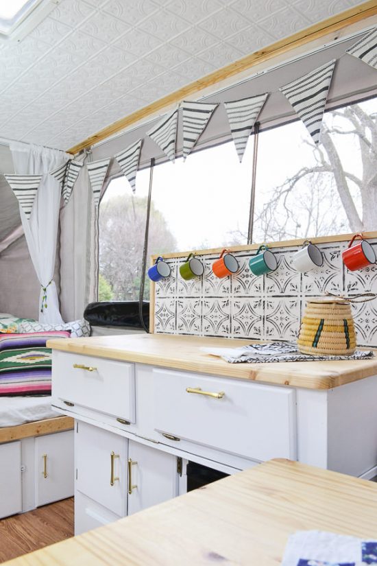 This camper is full of DIY projects - you'd never believe how it looked before. Pop up camper remodel with an eclectic vintage boho feel via Refresh Living.