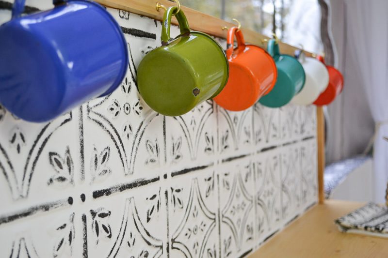 A great idea for a DIY back splash - painted ceiling tiles!