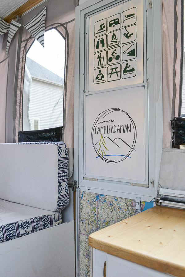 What a cool idea to update a door of a camper. I love the parks and recreation symbols of all the fun things to do while camping. Pop up camper remodel with an eclectic vintage boho feel via Refresh Living.