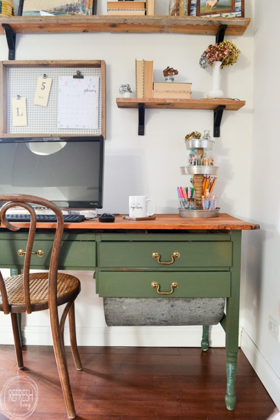 An antique baker's table becomes a desk by removing one of the flour drawers. Vintage modern office with natural wood. Dark green desk with natural wood top desk via Refresh Living.
