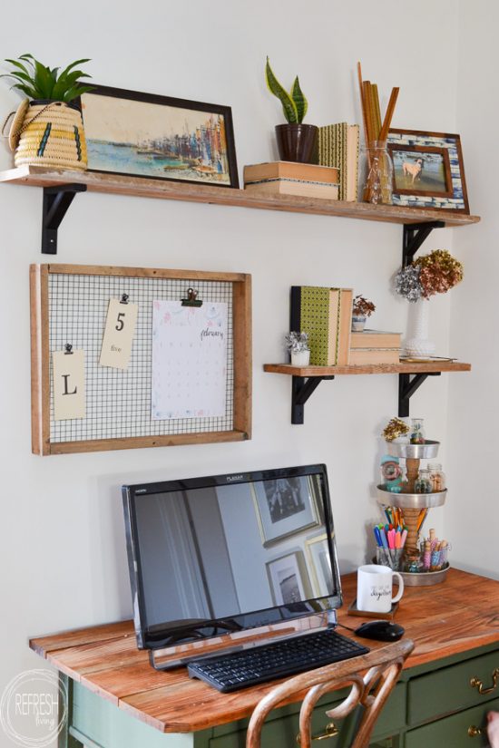 This office has a vintage farmhouse feel with modern touches including a dark green desk, brass and gold accents, and open shelves.