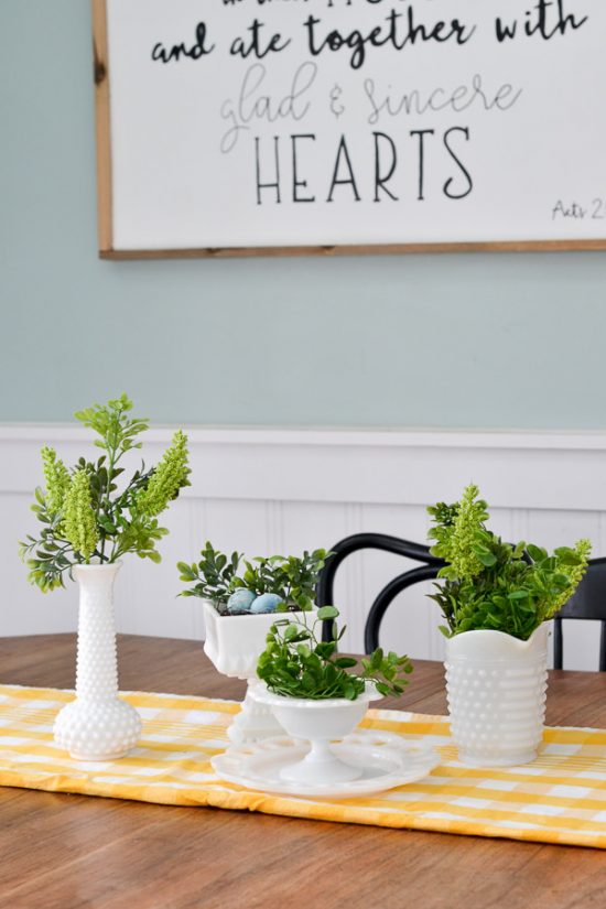 I love milk glass and this greenery looks perfect in it. This spring decor has a vintage farmhouse feel. Spring home tour with upcycled and vintage finds.