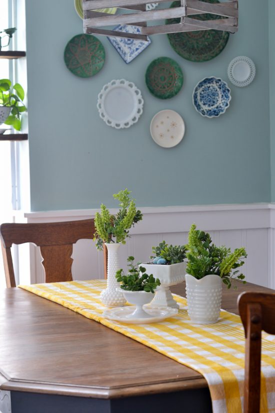 I love milk glass and this greenery looks perfect in it. This spring decor has a vintage farmhouse feel. Spring home tour with upcycled and vintage finds.