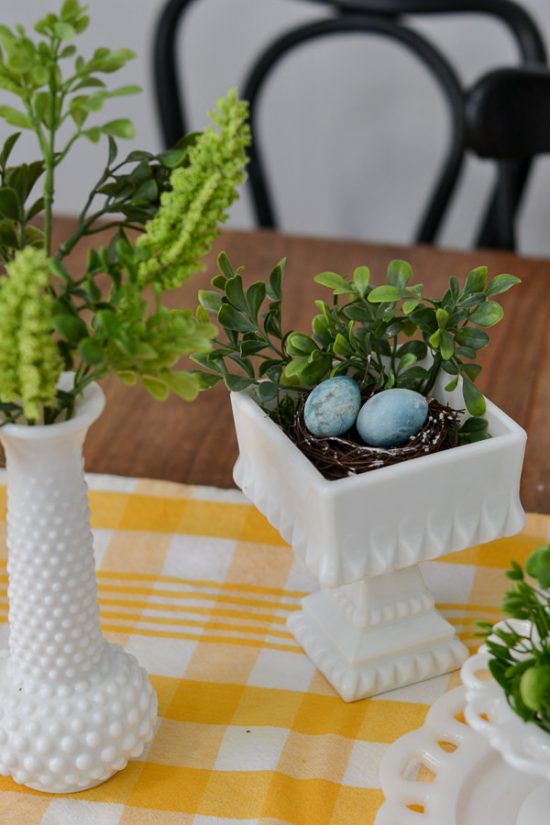 I love milk glass and this greenery looks perfect in it. This spring decor has a vintage farmhouse feel. Spring home tour with upcycled and vintage finds.
