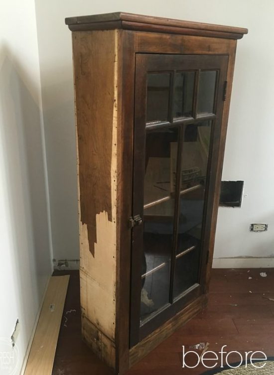 This cabinet with peeling veneer started off in pretty bad shape, but it looks amazing now with black paint, decorative floral paper, while still retaining some of the original wood finish.