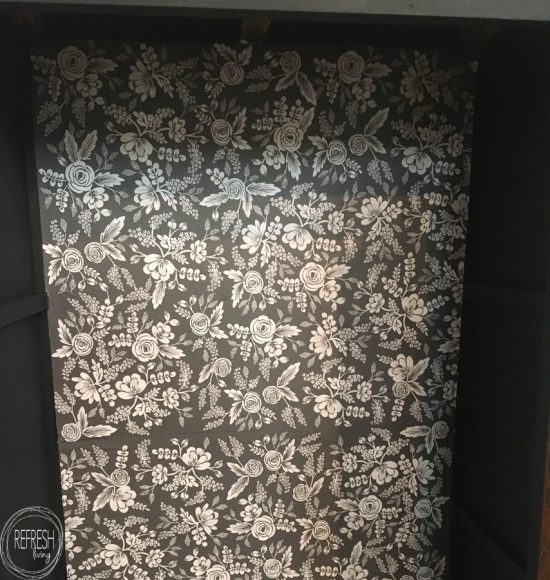 How to apply decorative paper to furniture on this black cabinet with black and white floral paper.