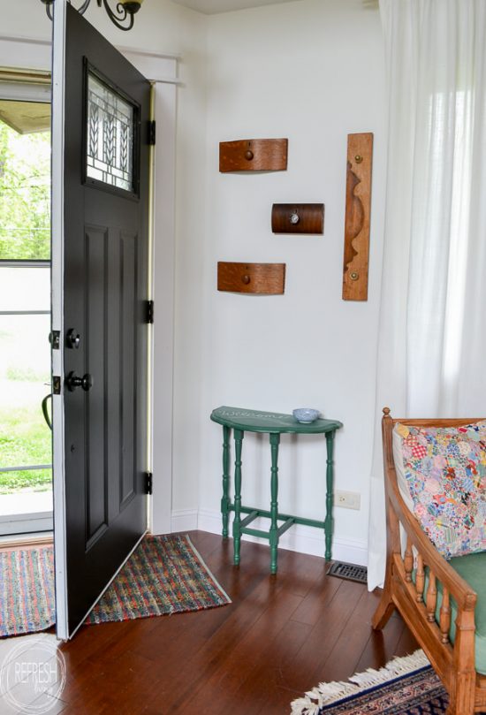 Love this idea for a coat rack for a small entryway! It's decorative and functional, and even better, it reuses old items (dresser drawer fronts) that would otherwise be thrown away.