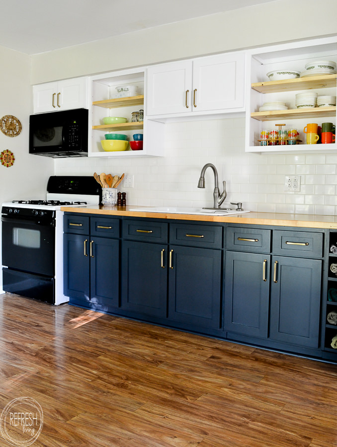 kitchen with dark blue lower cabinets and white upper cabinets with DIY cabinet refacing