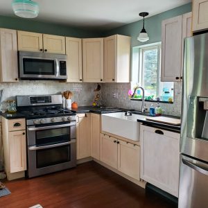 This boring kitchen with off white cabinets is going to be updated into a modern kitchen with vintage touches.